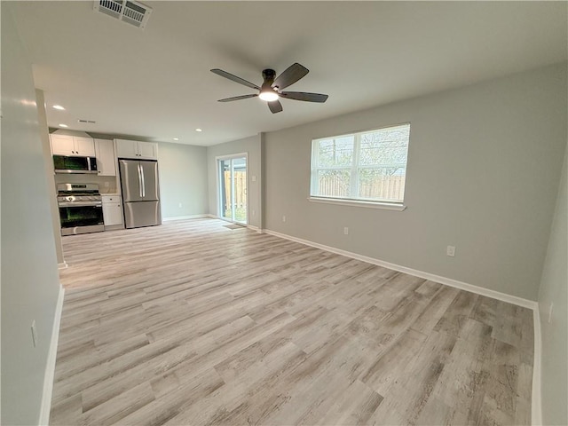 unfurnished living room with ceiling fan and light wood-type flooring