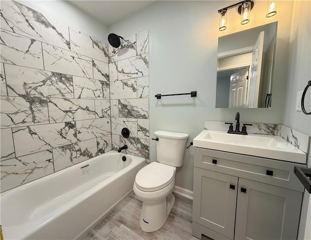 full bathroom with tiled shower / bath combo, vanity, wood-type flooring, and toilet