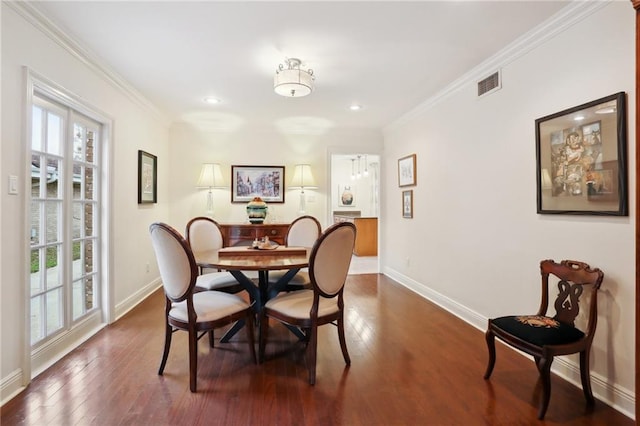 dining space featuring crown molding and dark hardwood / wood-style floors