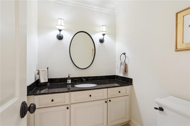 bathroom featuring crown molding, vanity, and toilet