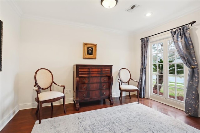 living area with dark wood-type flooring and crown molding