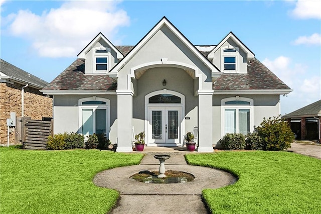 view of front of house with a front yard and french doors