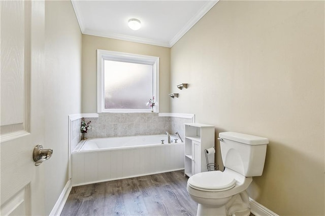 bathroom featuring ornamental molding, a tub to relax in, toilet, and wood-type flooring