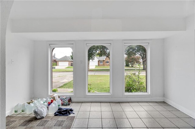 carpeted empty room featuring ceiling fan with notable chandelier and a wealth of natural light