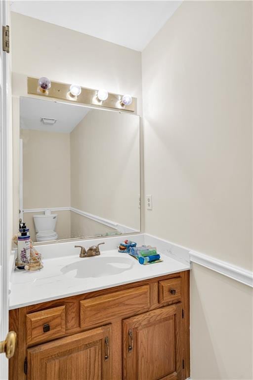 bathroom featuring vanity and toilet