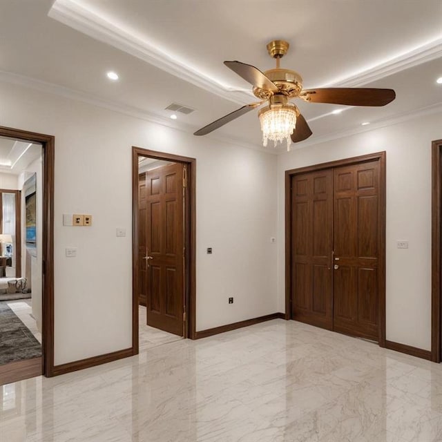 unfurnished bedroom with ornamental molding, ceiling fan, and a closet