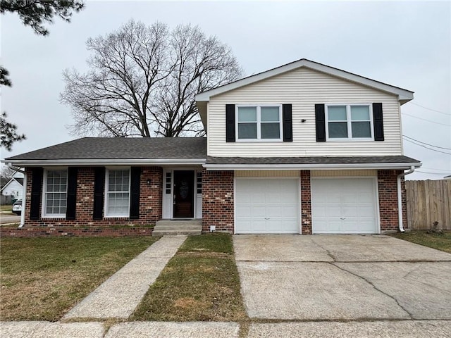 tri-level home featuring a garage and a front lawn