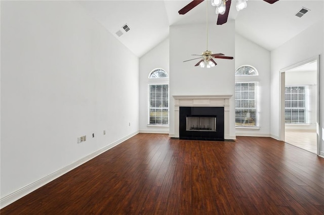 unfurnished living room with dark wood-type flooring and high vaulted ceiling