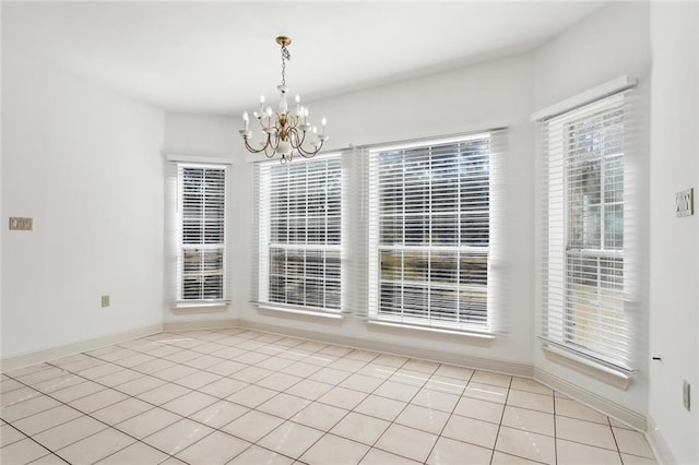 unfurnished dining area with light tile patterned floors and a chandelier