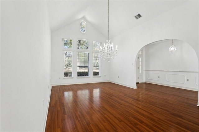 unfurnished living room with hardwood / wood-style flooring, lofted ceiling, and a notable chandelier