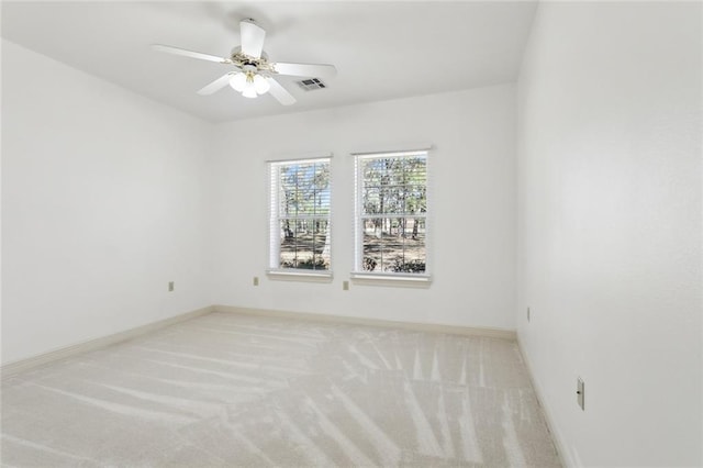 carpeted spare room with ceiling fan