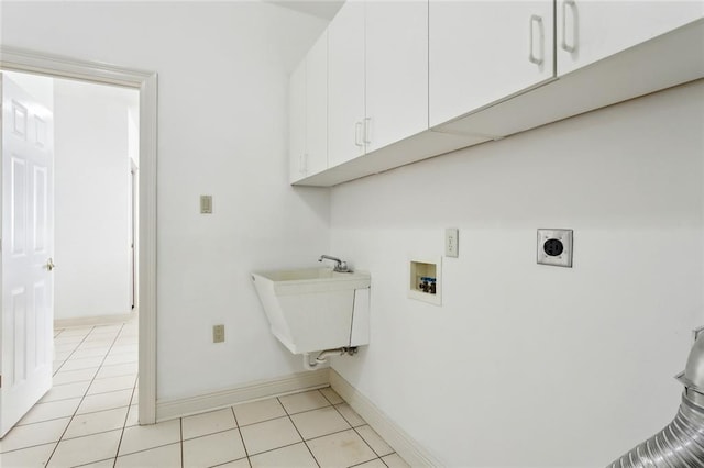 laundry room with sink, cabinets, light tile patterned floors, hookup for a washing machine, and hookup for an electric dryer