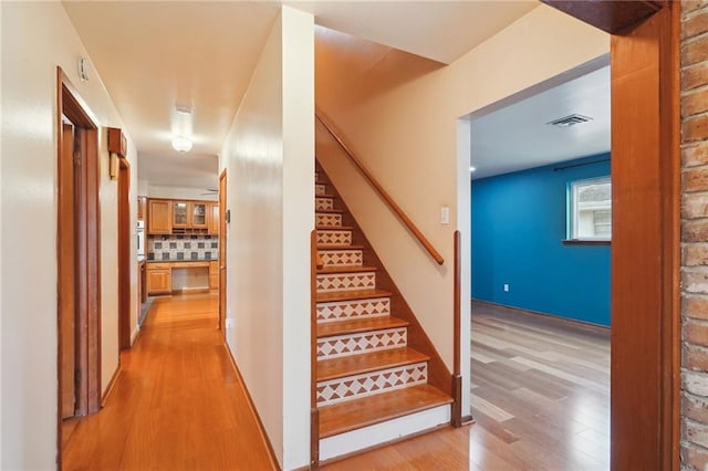 stairs with hardwood / wood-style flooring