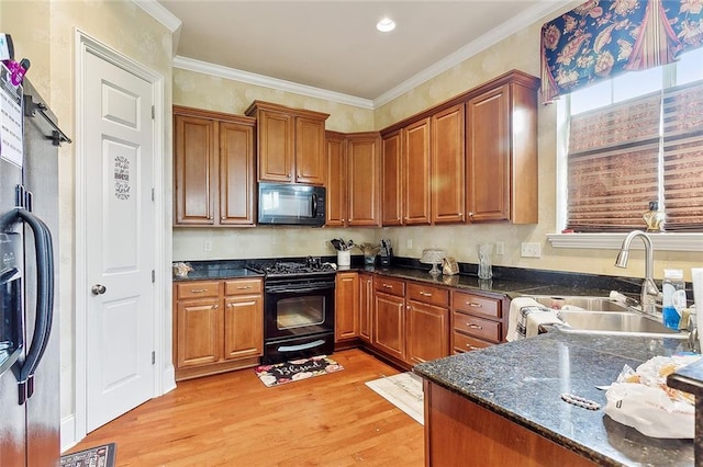 kitchen featuring crown molding, sink, light wood-type flooring, and black appliances