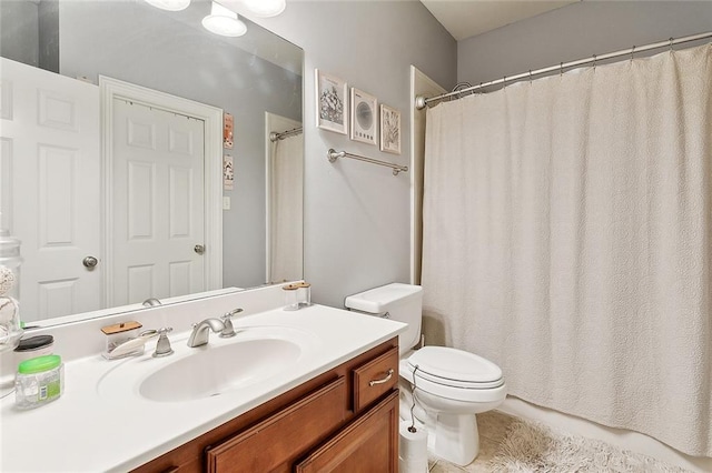 bathroom with vanity, tile patterned floors, and toilet