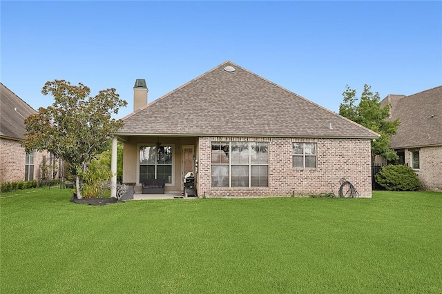 back of property featuring a yard and a patio