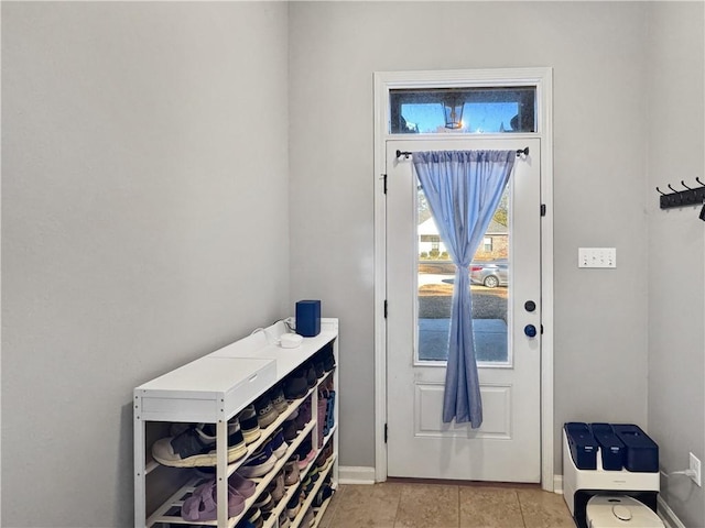 doorway with light tile patterned floors