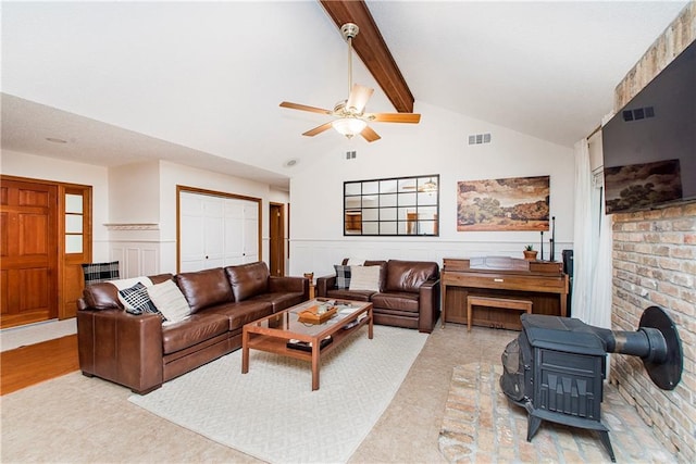 living room featuring vaulted ceiling with beams and ceiling fan