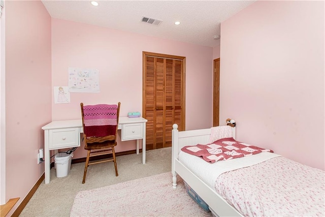 bedroom featuring light carpet and a closet