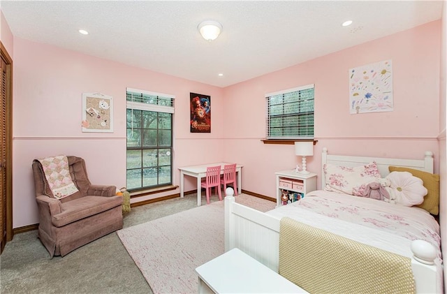 bedroom with multiple windows and carpet