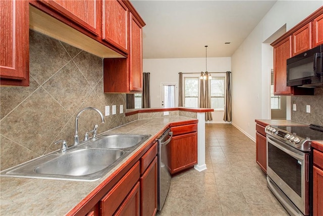 kitchen featuring appliances with stainless steel finishes, hanging light fixtures, sink, and decorative backsplash