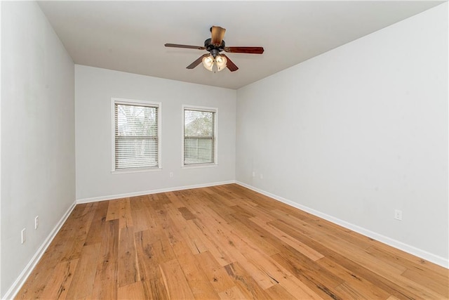 spare room with ceiling fan and light wood-type flooring