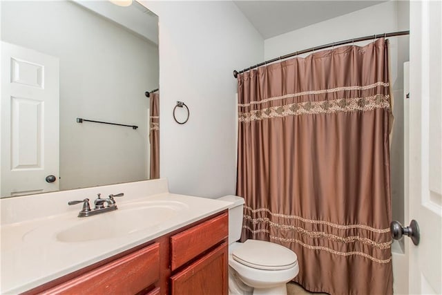 bathroom with vanity, curtained shower, and toilet