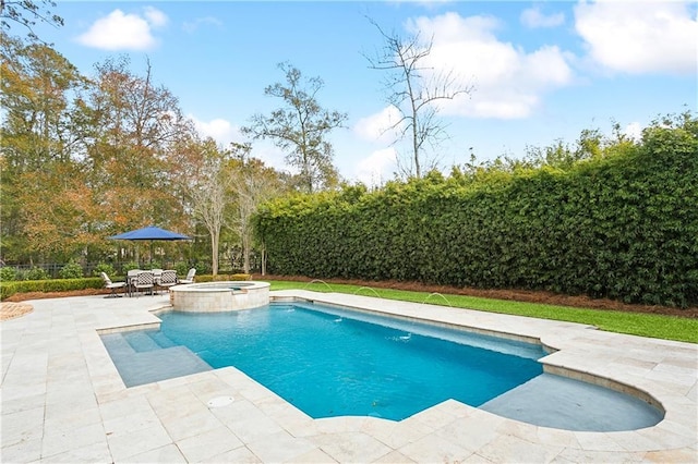 view of swimming pool with a patio area and an in ground hot tub