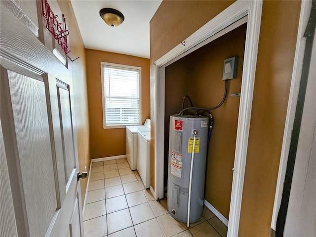 clothes washing area with water heater, light tile patterned floors, and independent washer and dryer