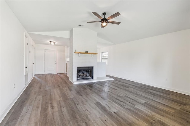 unfurnished living room featuring lofted ceiling, hardwood / wood-style flooring, a fireplace, and ceiling fan