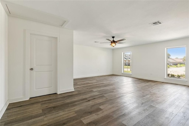 empty room with dark wood-type flooring and ceiling fan