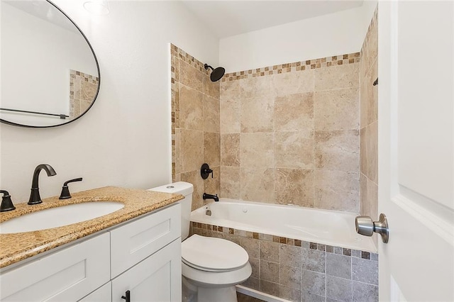 full bathroom featuring vanity, toilet, and tiled shower / bath combo