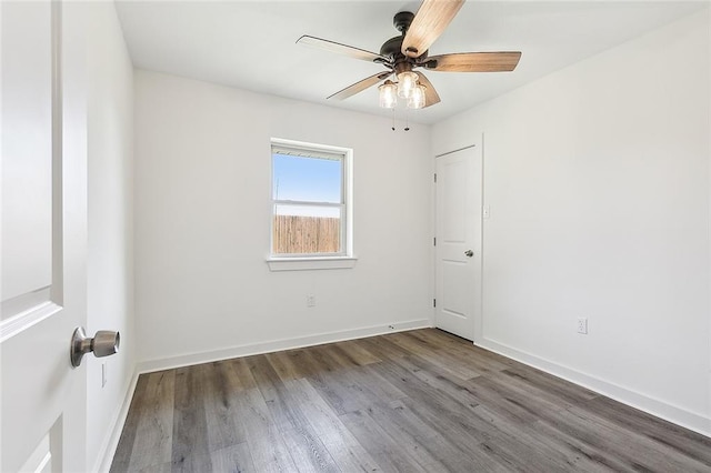 spare room with hardwood / wood-style flooring and ceiling fan