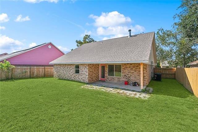 back of property with a yard and a patio