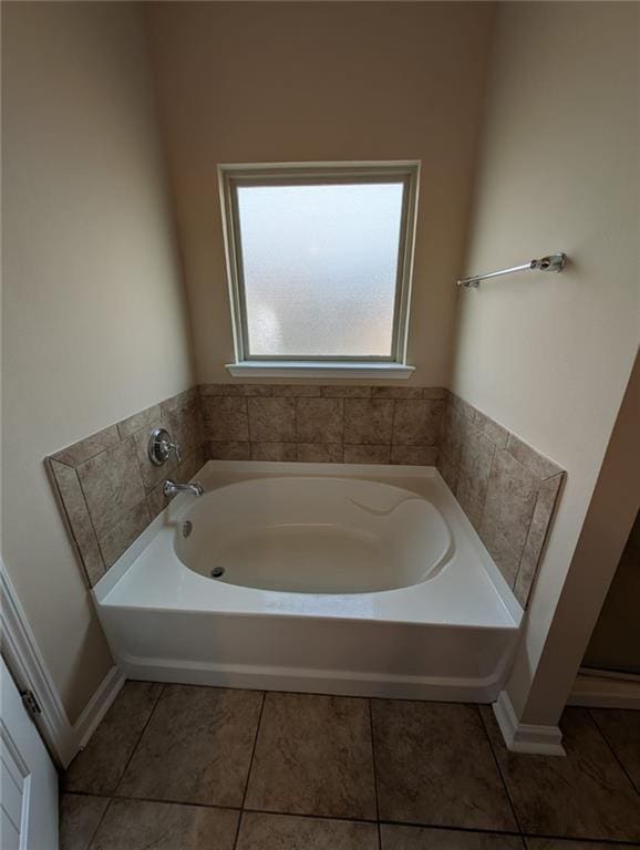 bathroom with tile patterned floors and a washtub