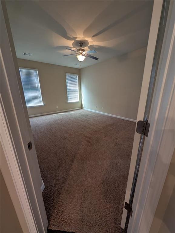 empty room featuring carpet and ceiling fan