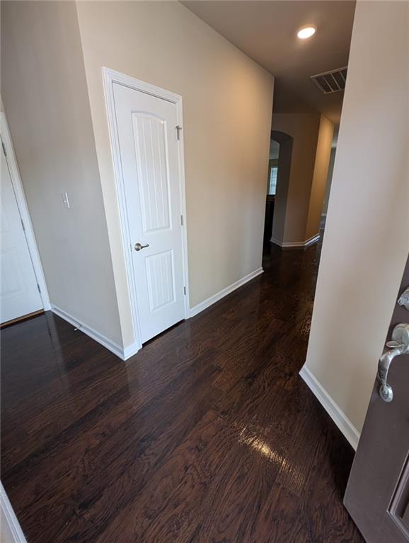 corridor featuring dark hardwood / wood-style floors