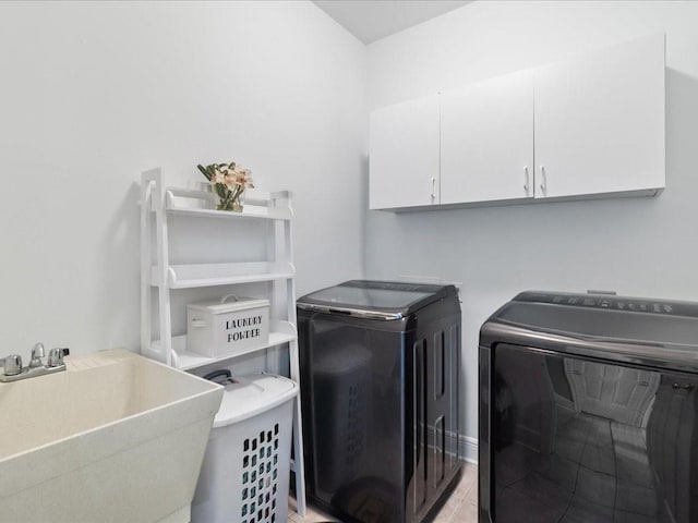 washroom featuring cabinets, washer and dryer, sink, and light tile patterned floors