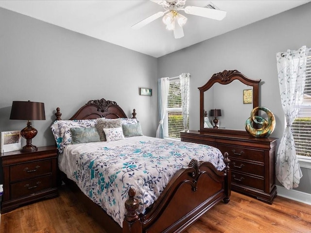 bedroom with hardwood / wood-style flooring and ceiling fan