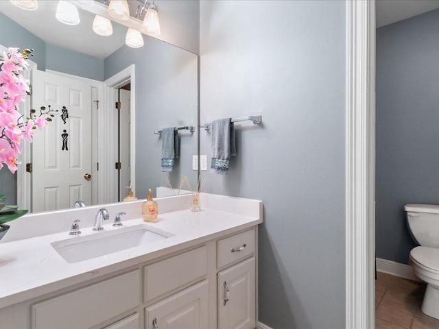 bathroom featuring tile patterned flooring, vanity, and toilet