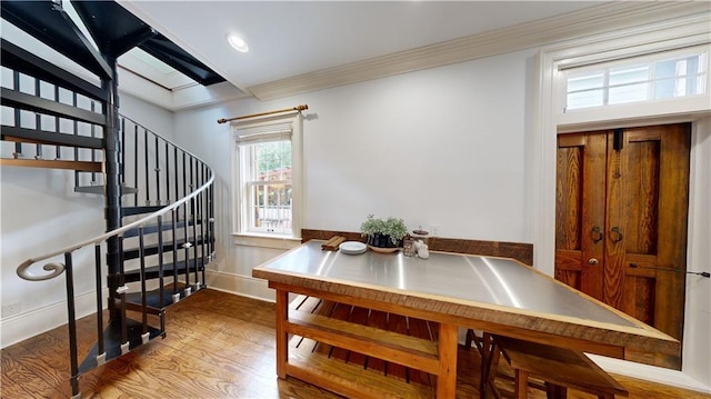 dining room featuring hardwood / wood-style flooring and ornamental molding