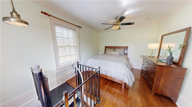 bedroom featuring wood-type flooring, ornamental molding, and ceiling fan