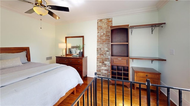 bedroom featuring crown molding, hardwood / wood-style floors, and ceiling fan