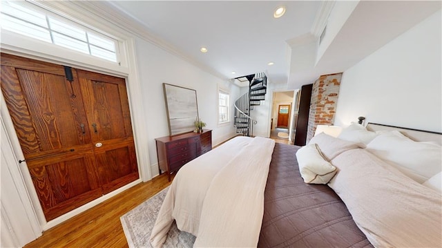 bedroom with dark wood-type flooring and crown molding