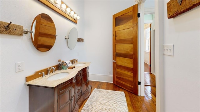 bathroom with vanity and hardwood / wood-style flooring