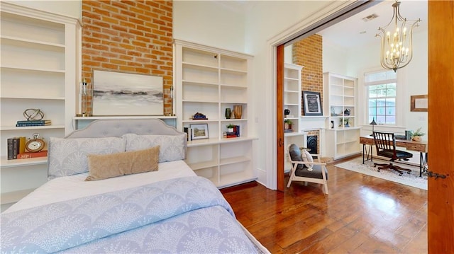 bedroom featuring dark hardwood / wood-style flooring and an inviting chandelier