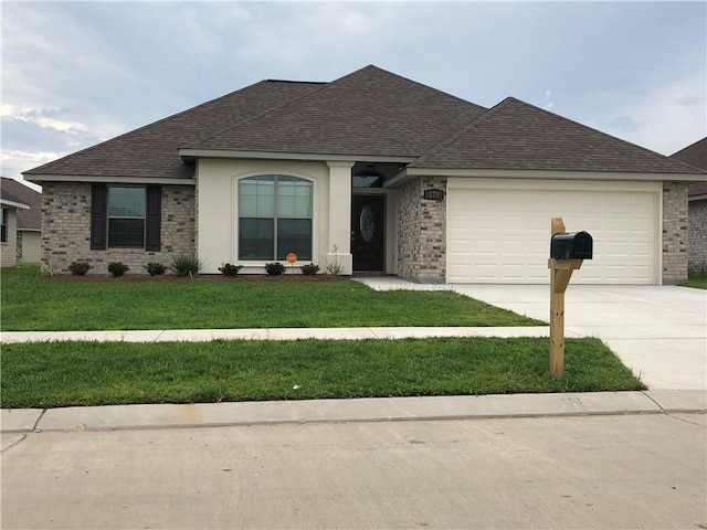 ranch-style house featuring a garage and a front yard