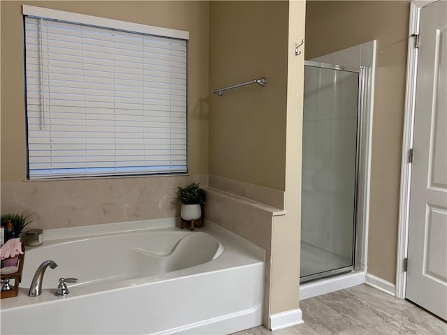 bathroom featuring independent shower and bath