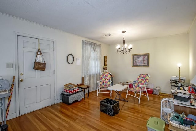 interior space with an inviting chandelier and wood-type flooring