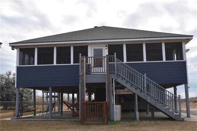 back of property featuring a patio area and a sunroom